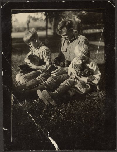 Man with Children and Puppies in Yard by Louis Fleckenstein