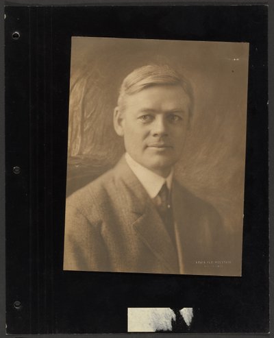 Portrait of a Man Seated Before Painted Backdrop by Louis Fleckenstein