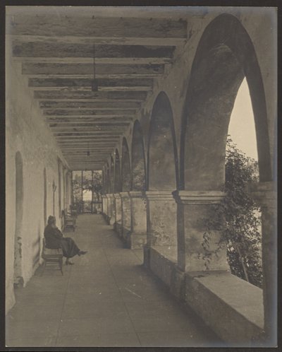 Woman Sitting in Mission Hallway by Louis Fleckenstein