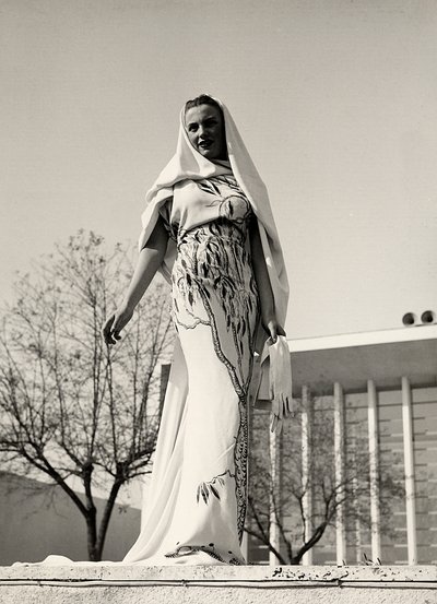 Model in an evening dress of floral print fabric, created by the couture house 