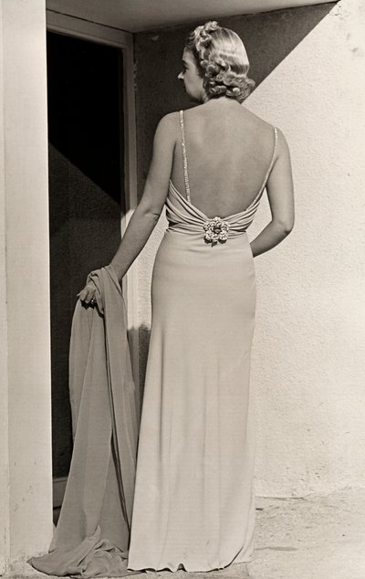 Model seen from the back wears evening dress from the couture house 