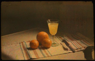 Still life photograph of fresh oranges and a glass of orange juice by Luis Marden