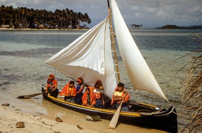 Women with gold nose rings of Cuna tribe of Mulatas aka San Blas Islands paddle and sail by Luis Marden