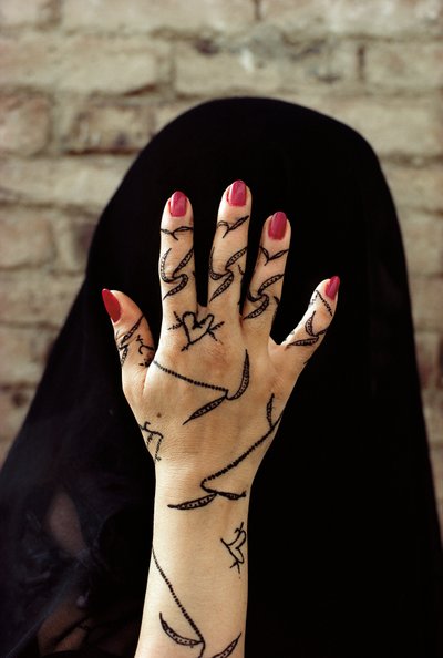 Yemenite woman with her hands decorated with henna dye in North Yemen by Lynn Abercrombie