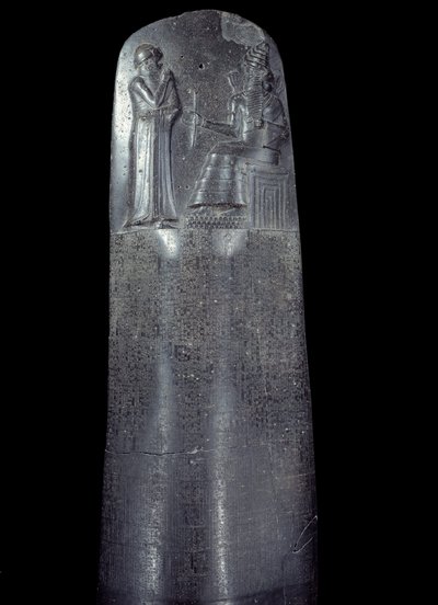 Mesopotamia: stele in diorite of the Code of Laws of Hammurabi. It is covered with cuneiform inscriptions and at the top King Hammurabi stands before the sun god of Mesopotamia, Shamash, divinity of Justice by Mesopotamian