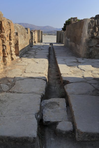 Minoan archeological site of Phaistos. Wide corridor with a drainage duct by Minoan