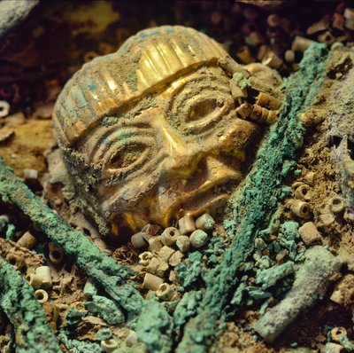 Gold head bead buried in the Moche royal tomb of the Old Lord of Sipan by Nathan Benn