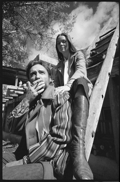 Dennis Hopper and wife Michelle Phillips on a ladder in New Mexico by Orlando Suero