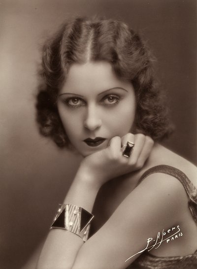 Close-up of a young woman resting her chin on her hand by P. Apers