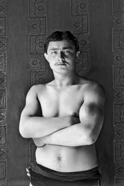 Portrait of a traveling circus wrestler, passing by Andelot Blancheville (Haute Marne). Photograph, circa 1886, by Paul Emile Theodore Ducos (1849-1913). by Paul Emile Theodore Ducos