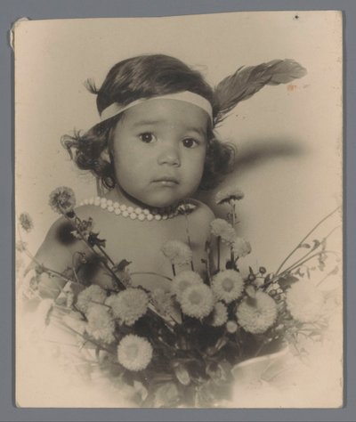 Portrait of an Unknown Child with a Headband and a Bouquet of Flowers by Paul Rollman