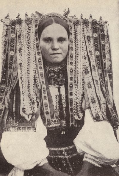 Czech woman wearing a headdress of ribbons where each ribbon denotes a suitor she refused in marriage by Photographer Czech