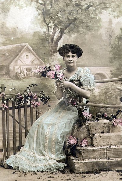 Woman with garland of flowers, postcard, c. 1900 by Photographer French