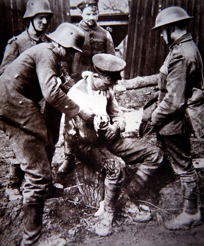 WWI German medical orderly tending a wounded British soldier on the Western Front by Photographer German