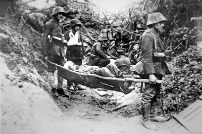 WWI German Soldiers Carrying a Wounded Comrade in Improvised Stretcher, Near Soissons, June 1918 by Photographer German