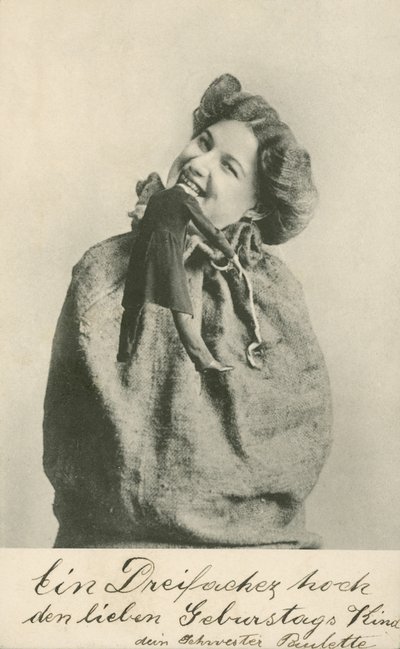 Woman biting the head off a doll by Photographer German