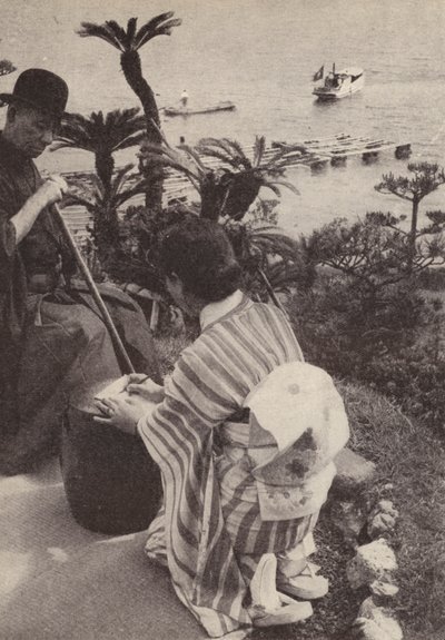 Japanese businessman and his secretary taking shorthand notes by Photographer Japanese
