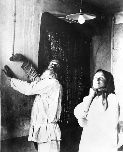 Peasants in the village of Bryansk Gubernia trying out their first electric light bulb by Photographer Russian