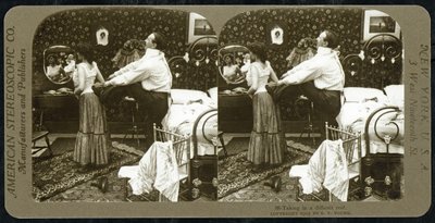 Stereoscopic card depicting a woman being laced into a corset by R.Y Young