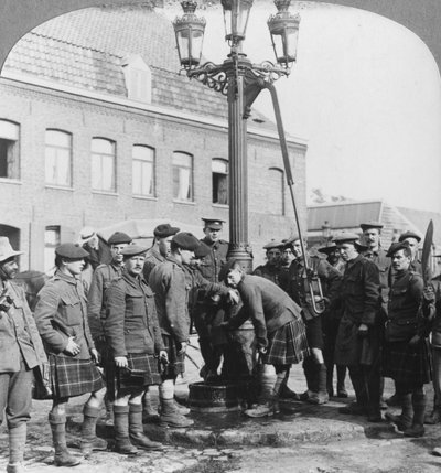 Soldiers filling their water bottles at the town pump La Gorgue, France, World War I, c1914-c1918 by Realistic Travels Publishers