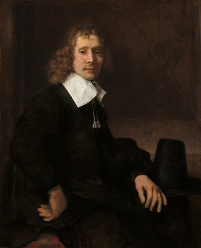 A Young Man Seated at a Table (possibly Govaert Flinck) by Rembrandt van Rijn