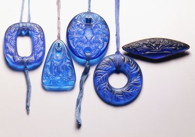 Four Turquoise Glass Pendants and a Gilt-Metal Mounted Glass Brooch by Rene Jules Lalique
