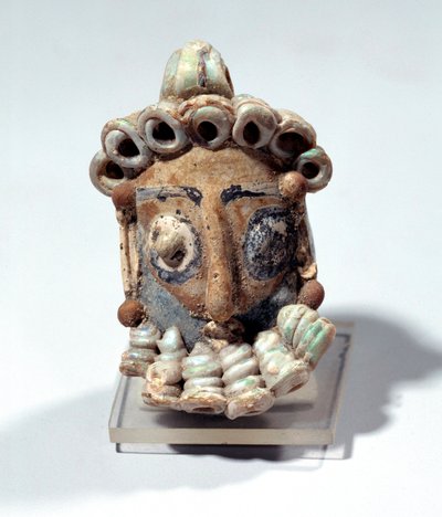 Oriental antiquity: amulet in the shape of a male head found in a tomb in Carthage. Punic period, varnished land. 400-300 BC. Paris, Louvre Museum by Roman