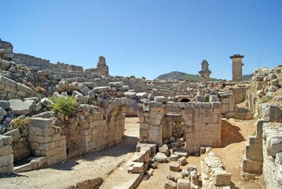 View through the vaulted entrance of the Xanthos theatre into the Orchestra pit, showing pillar and Harpy tomb, Xanthos, Turkey by Roman