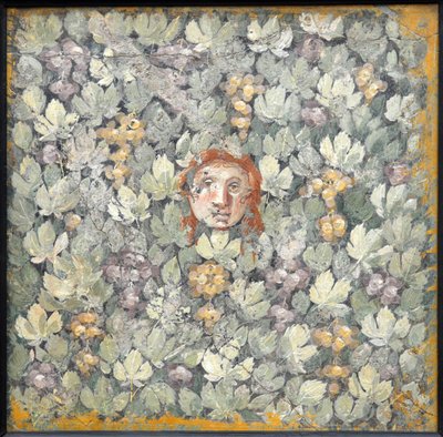 Mask on vine leaves and bunches of grapes, 1st half of 1st century AD by Roman Pompeian wall painting.