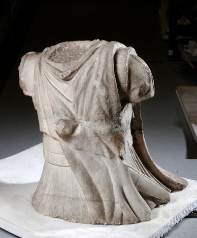 Sculpted torso of a cavalryman with heavy worn cloak by Roman Roman