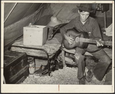 White Migrant Strawberry Picker on Bed in Tent Near Hammond, Louisiana by Russell Lee
