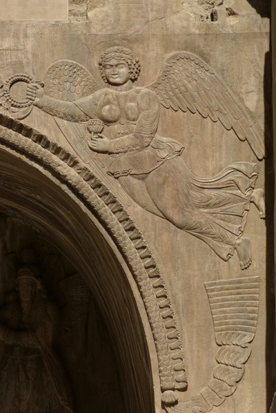 Genius holding a bowl of fruit, symbolising plenty, from a spandrel of an aivans, 590-628 by Sasanian School