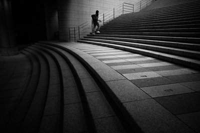 Man Ascending Urban Steps by Satoshi Hata