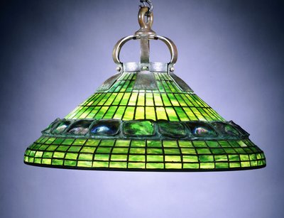 A leaded glass turtleback tile and bronze chandelier by School American