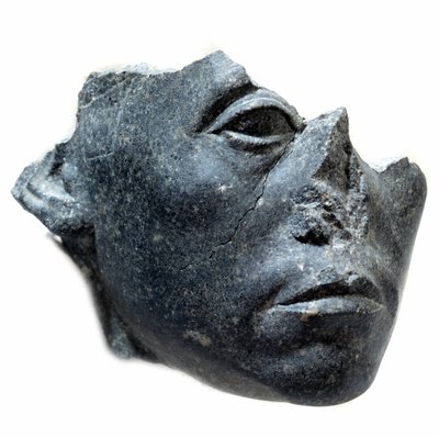 Ancient Egyptian Art: Head of King Sesostris III. Statue fragment. Black granite sculpture, circa 1900 BC by School Egyptian