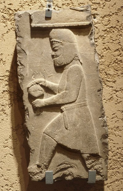 A Mede at the Royal Court of Persepolis carrying a covered vessel by School Iranian