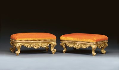 A matched pair of Italian rococo giltwood footstools by School Italian