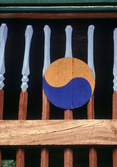 Yin and Yang Symbol on a Wooden Barrier by School Korean