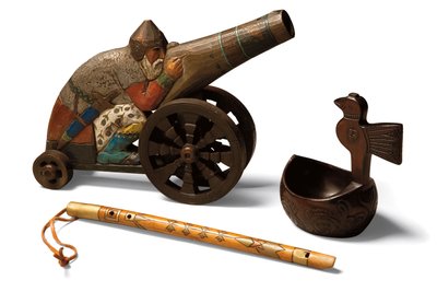 A toy limewood Bogatyr, a birchwood flute and a birchwood Kovsh, c.1900 by School Russian