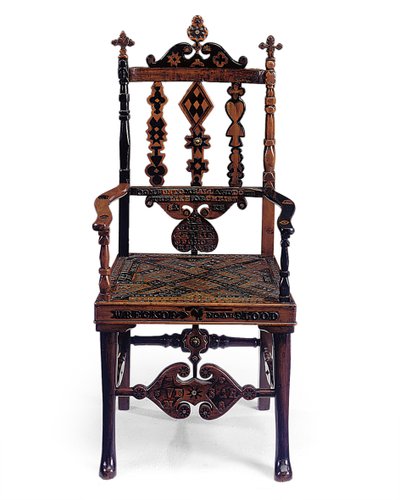 Inlaid and carved open armchair encoded with a patchwork of various phrases by Scottish School