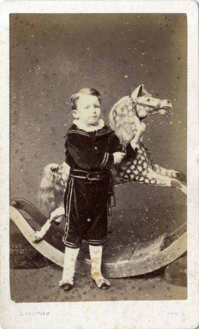 Young Boy Standing by a Rocking Horse by Silas Eastham