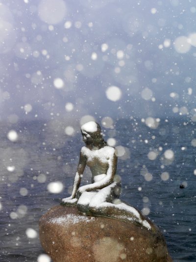 Snow storm on The Little Mermaid statue by Edvard Eriksen, winter in Copenhagen Denmark, 2022 by Sisse Brimberg