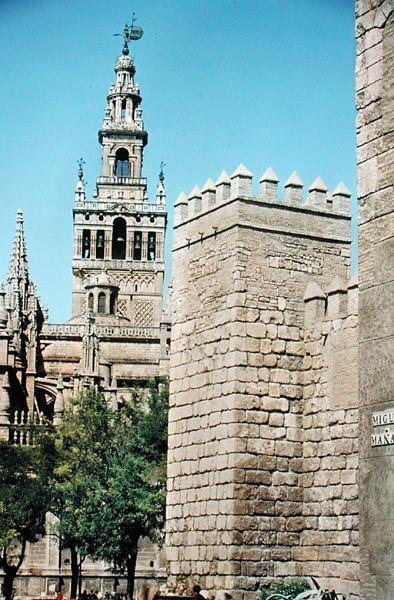 View of La Giralda Tower and one of the towers of the Reales Alcazares by Spanish School