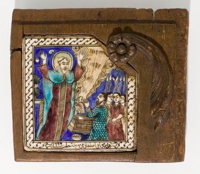 A signed and dated Syrian ceramic tile, painted in manganese, blue and brown, dated 1699 by Syrian School