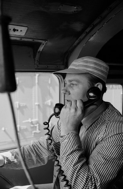 Charles Brockman, engineer of the Great Northern Railroad, speaks on radio phone from train by Ted Spiegel