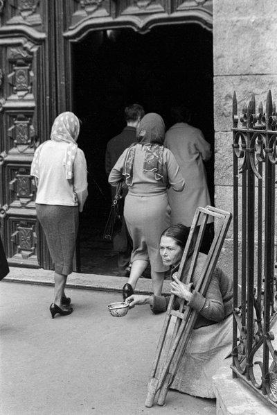 Crippled woman begging as pilgrims enter Sanctuary of Monserrate, Bogota, Colombia by Ted Spiegel