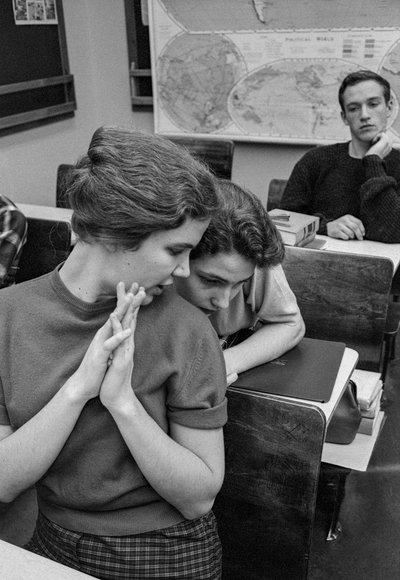 Female students socialize and chat in classroom at James A. Garfield High School by Ted Spiegel
