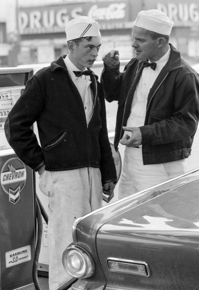 Instructor speaking with a young man training to be gas station attendant at Chevron station by Ted Spiegel