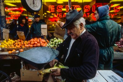 Man Peeling an Ear of Corn at market, Philadelphia by Ted Spiegel
