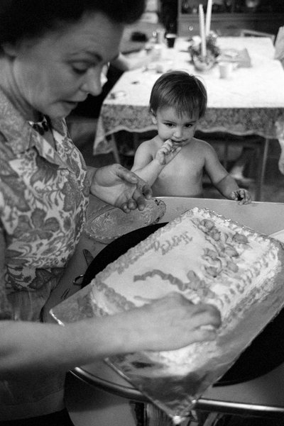 Mildred Cooper, a truck driver, decorates a birthday cake for one of her grandchildren by Ted Spiegel